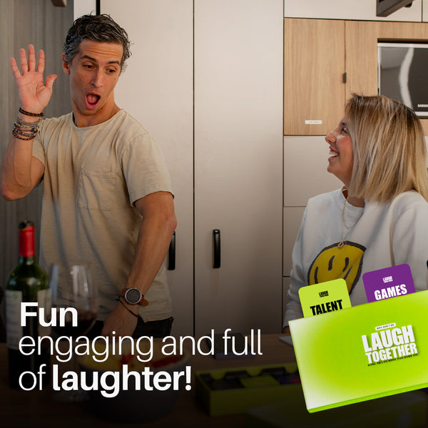 Couple laughing while playing Laugh Together card game at home